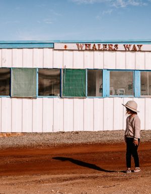 A girl stands out the front of a building in Whalers Way. (Image: Kristy Billing @gypsyandherwild)