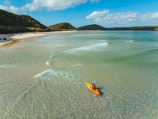 An aerial shot of a kayaker at Double Island Point in Rainbow Beach. (Image: Visit Sunshine Coast)