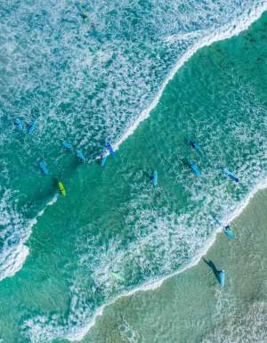Aerial shot of surfers at Redgate Beach in Margaret River. (Image: Tourism Western Australia)