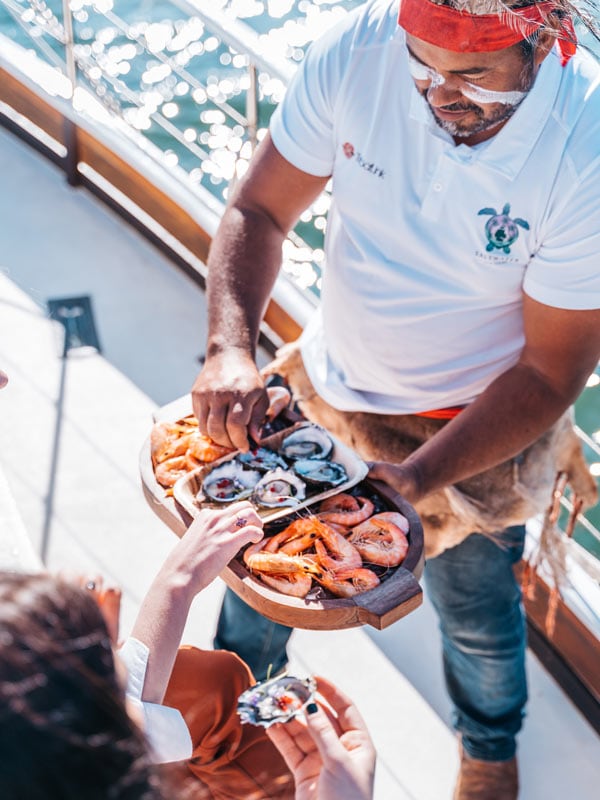 Group enjoying bush tucker inspired catering. (Image: Tourism and Events Queensland)