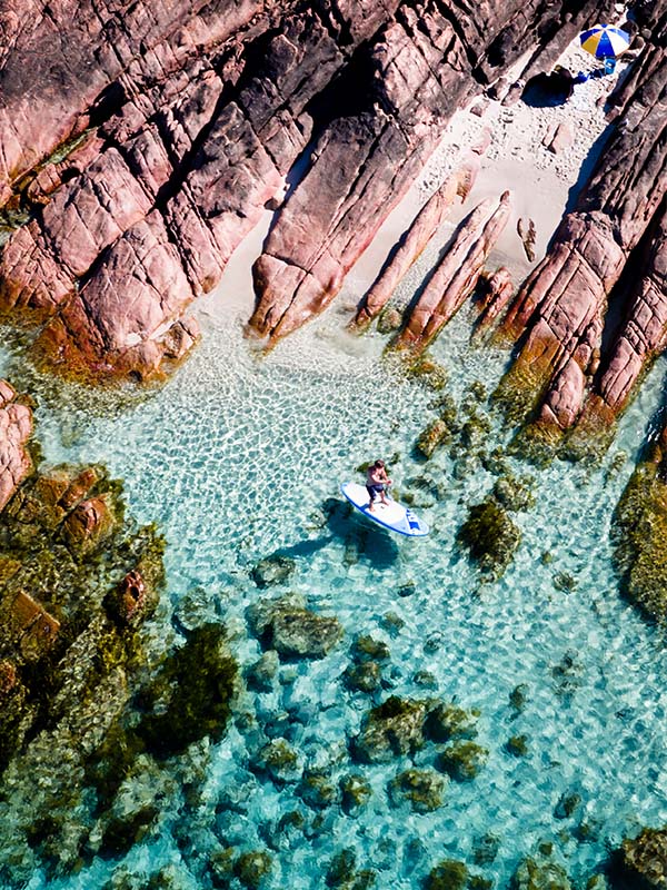 Aerial view of person stand-up paddle boarding