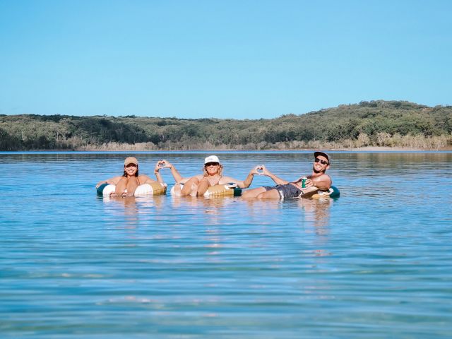 three people floating in water on k'gari fraser island during with Drop Bear Tours