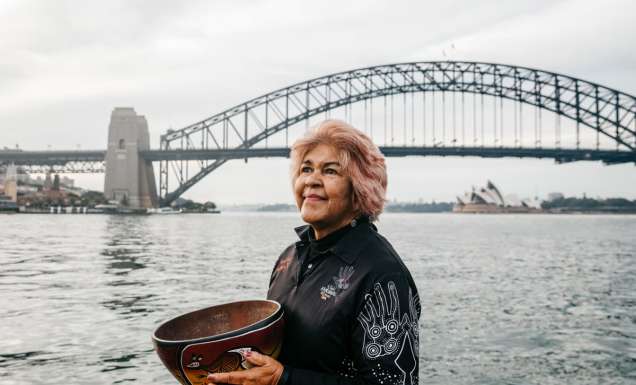Margret Campbell standing in front of the Sydney Harbour Bridge. (Image: Destination NSW and Margret Campbell)