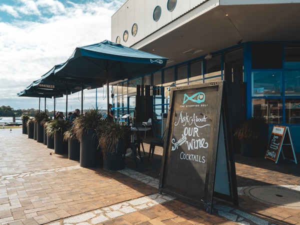 a waterfront restaurant with huge umbrellas outside at Starfish, Batemans Bay