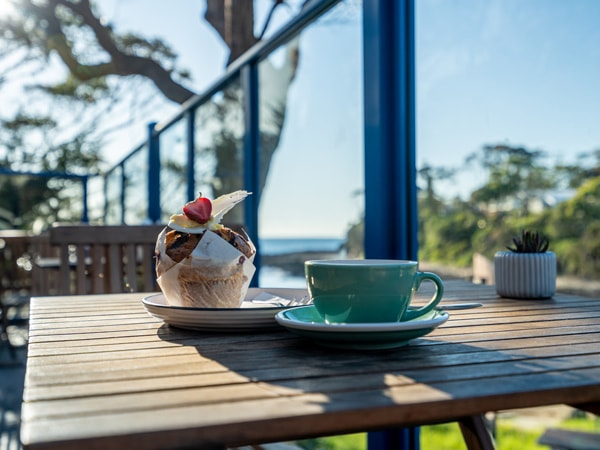 a cup of coffee and pastry on the table at Cafe Three66