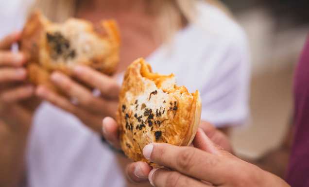 Couple enjoying pies from The Upper Crust pie shop, Collaroy (Image: Destination NSW)