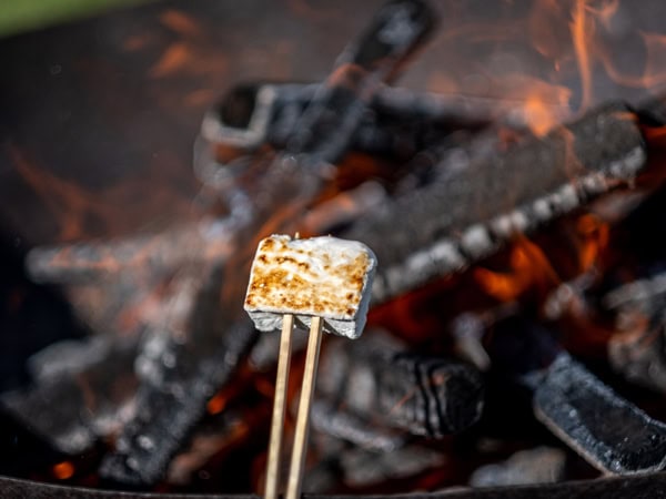 roasting marshmallow in fire at The Agrarian Kitchen, Hobart