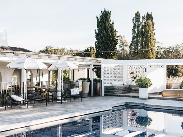 an outdoor pool with sun loungers at The Oaks Ranch, Batemans Bay