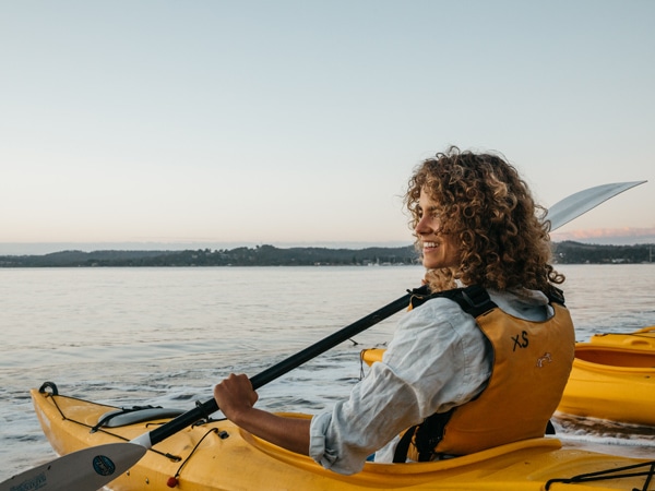 a woman kayaking along Batemans Bay, Clyde River Oyster Tasting Kayak Tour