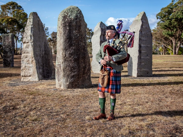 A piper piping at the Australian Standing Stones in Glen Innes, NSW, Australia