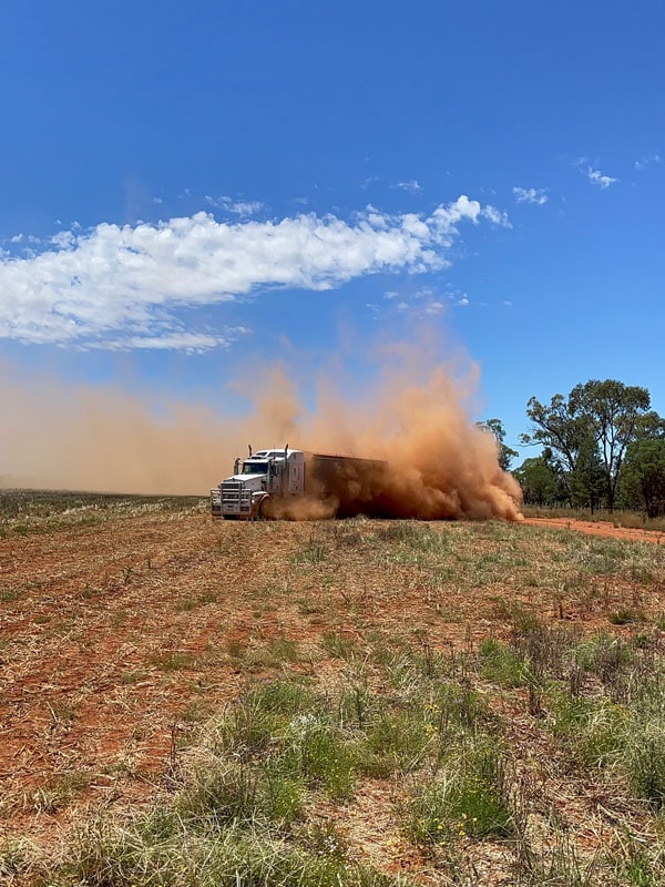 A truck ploughs through a grain field in NSW, Australia