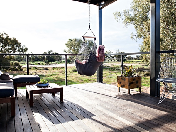 Woman in a swing hammock in Callubri Station, NSW, Australia