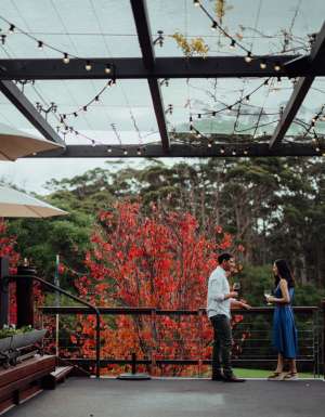 a couple enjoying wine on the outdoor deck of Leeuwin Estate, Margaret River