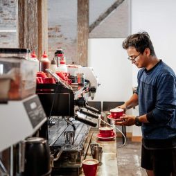 Barista making coffee at Bread + Butter Launceston