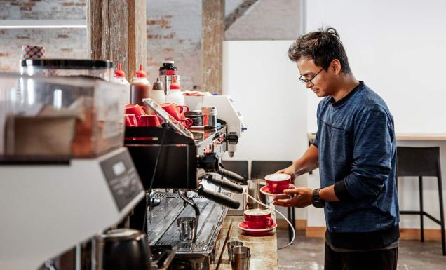 Barista making coffee at Bread + Butter Launceston