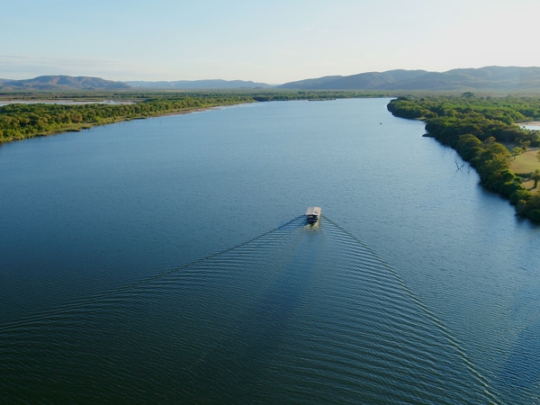 Looking out over the Ord River with a boat on it. 