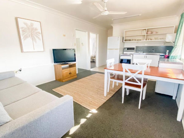 Well-appointed dining and living room inside Pacific Sun Bargara