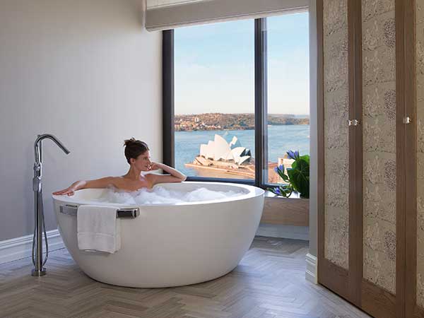 Woman in bath harbour views, Royal Suite, Four Seasons Sydney