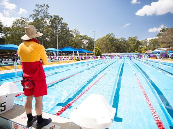 a person standing at the outdoor lap pool of Yeronga Park Swimming Complex, Brisbane
