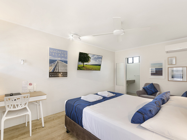 a whitewashed bedroom at Beach House Motel, The Strand, Townsville