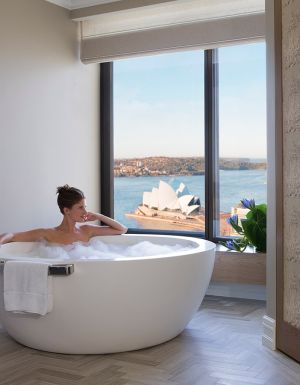 Woman in bath harbour views, Royal Suite, Four Seasons Sydney