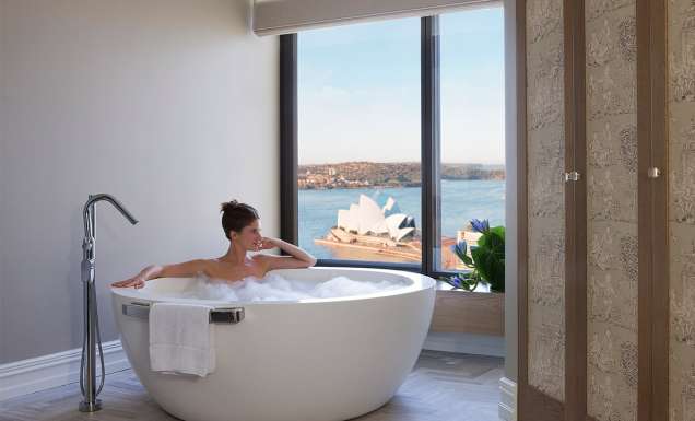 Woman in bath harbour views, Royal Suite, Four Seasons Sydney