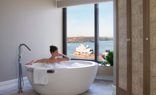 Woman in bath harbour views, Royal Suite, Four Seasons Sydney
