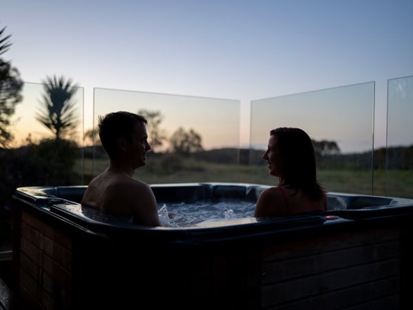a couple relaxing in a tub at Alure Stanthorpe