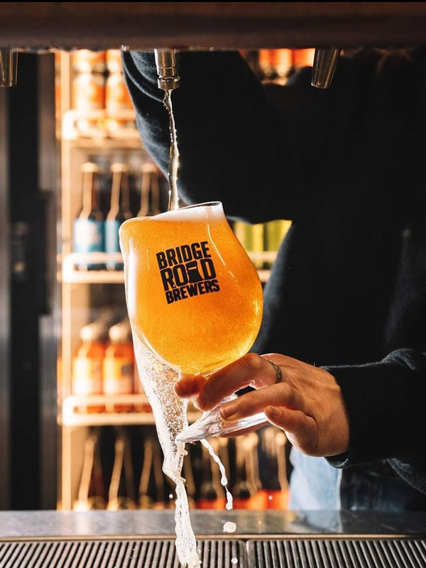 a bartender pouring tap beer into a glass at The Dispensary Bar & Diner, Bendigo