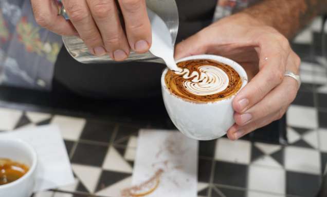 Pouring milk over coffee at Ray’s Patisserie and Cafe, Darwin