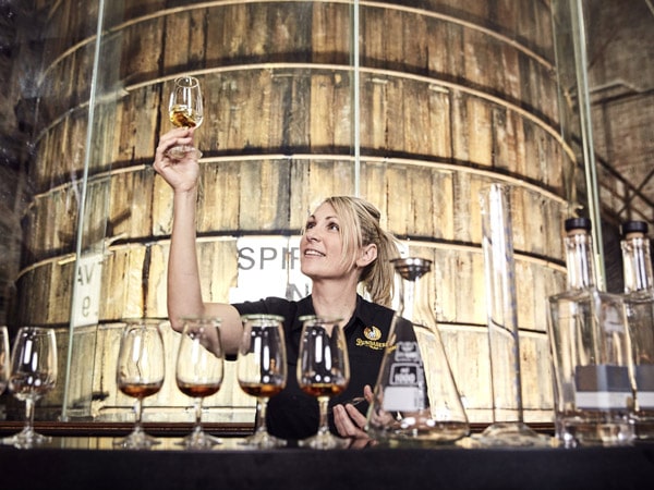 a woman blending her own glass of rum at Bundaberg Rum Distillery