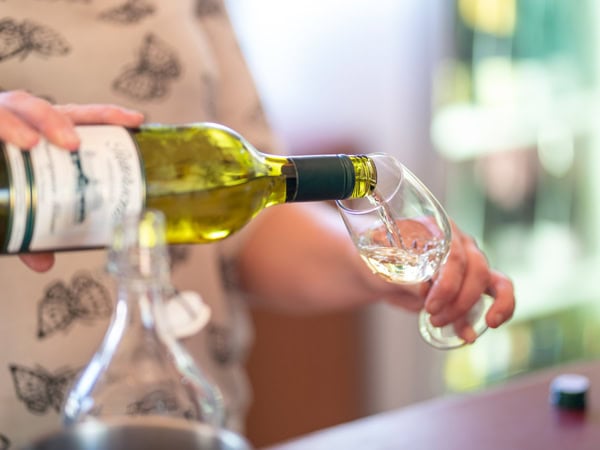 pouring wine into a glass at Petersons Armidale Winery & Guesthouse