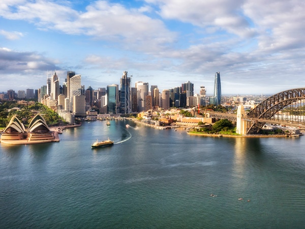Cityscape of Sydney Harbour with the opera house to the left and the harbour bridge to the right