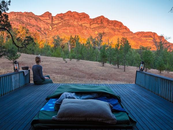 Woman with sleeping bag at the Elder Camp on the Arkaba Walk in South Australia's Flinders Ranges.