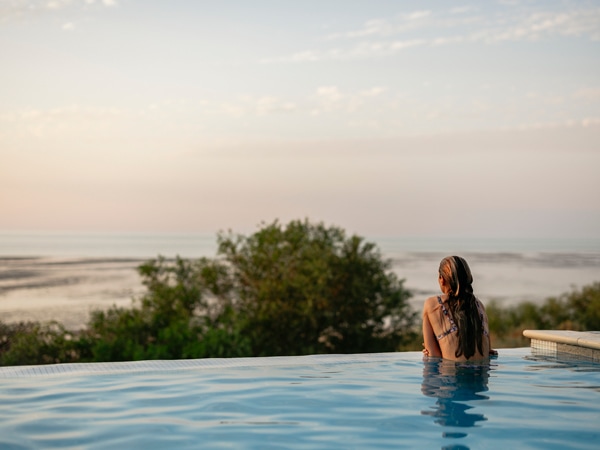 Woman is swimming at Eco Beach swimming pool.