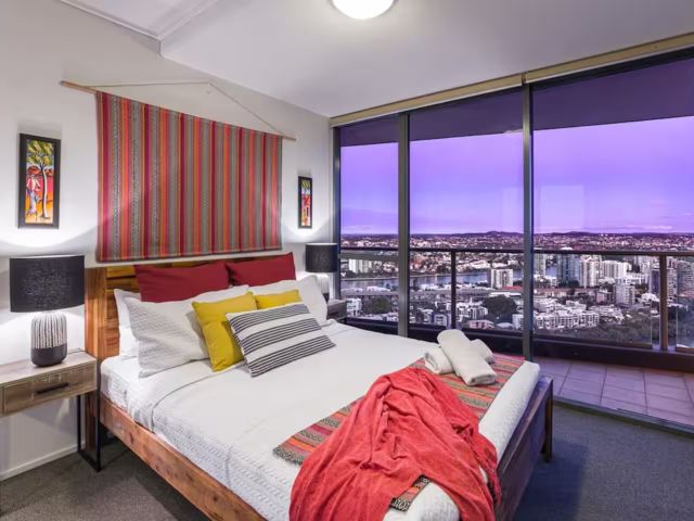 a bedroom with city views at African Escape, South Bank