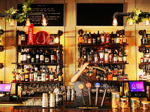 a bartender preparing drinks at Shaw & Co, Townsville