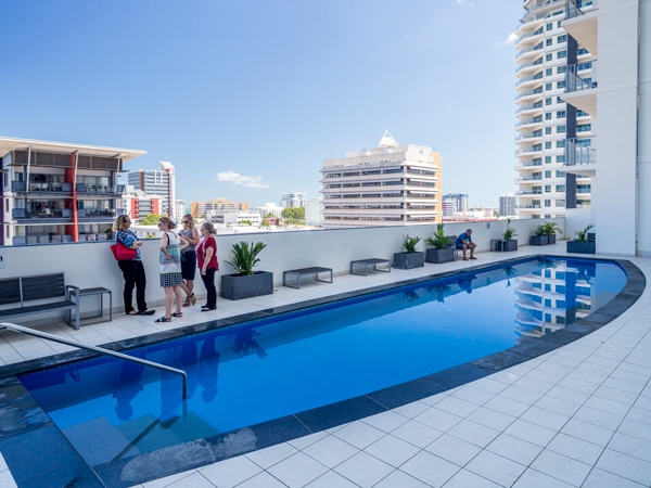 friends gather by the pool at Oaks Darwin Elan Hotel
