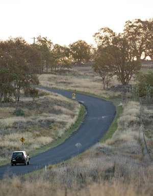 Car driving through the New England countryside in Uralla.