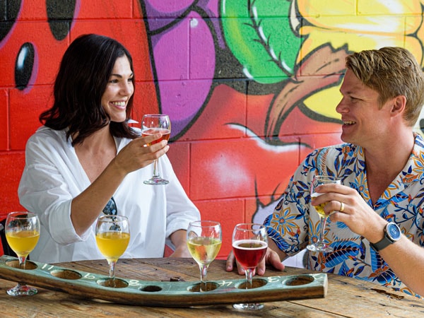 two people tasting some wines at Ohana Cider House & Tropical Winery
