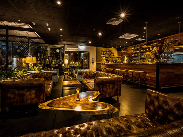 the dimly lit bar interior of Charlie’s of Darwin