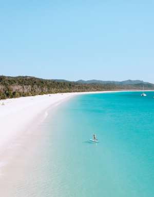 Stand up paddleboarder on Whitehaven beach.