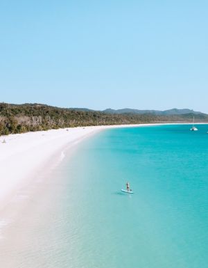 Stand up paddleboarder on Whitehaven beach.