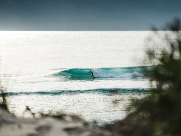 Surfing waves at Martha Lavinia Beach in Tasmania