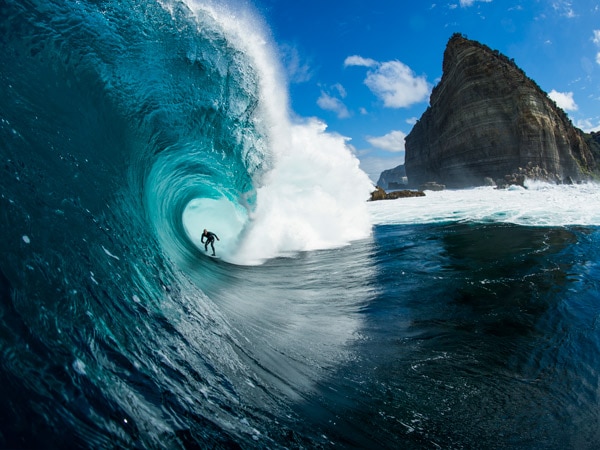 Man surfing a wave at Shipstern Bluff in tasmania