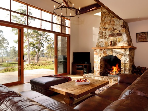 a rustic lodge with a fireplace at Adventure Bay Retreat, Bruny Island