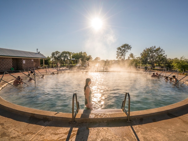 woman enjoying a relaxing day in a naturally heated thermal pool at the Artesian Bore Baths, Lightning Ridge