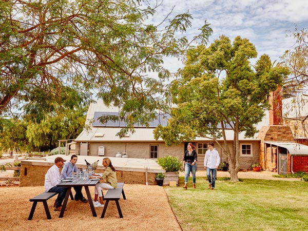 a group of people sitting outside the 1858 Barossa Accommodation
