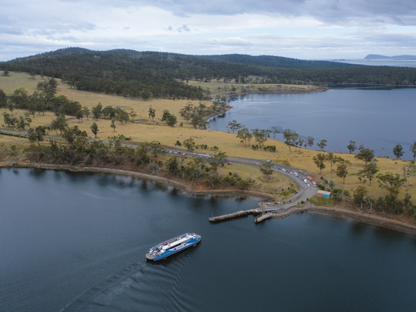 aerial shot of a ferry across the waters of Bruny Island