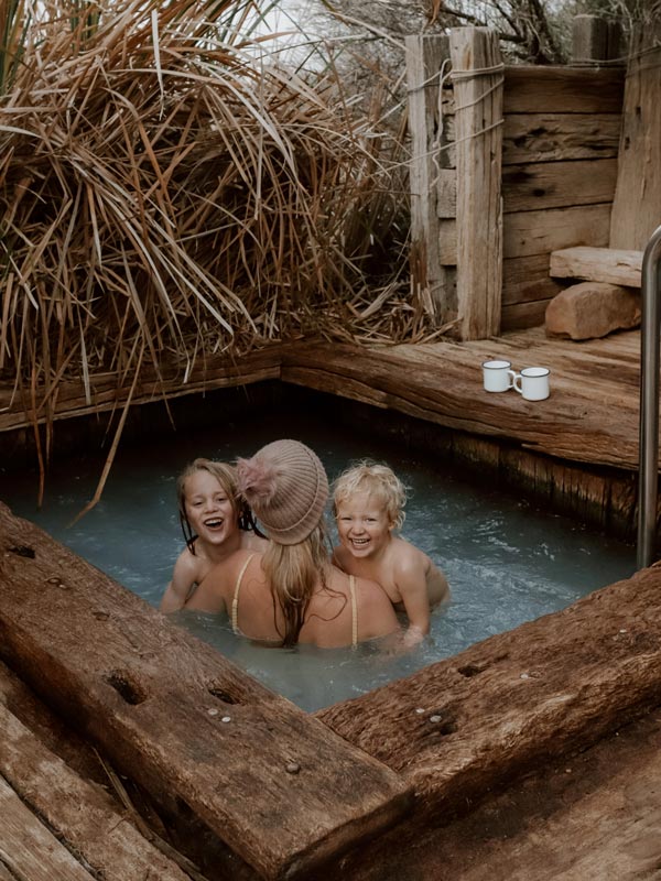a mother with her kids enjoying their time together while dipping in a small bore bath